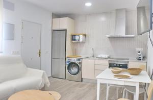 a small kitchen with a washing machine in a room at Chalet Ruperto II in Conil de la Frontera