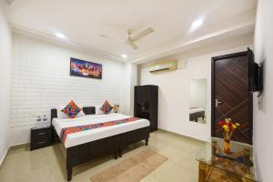 a bedroom with a bed and a television in a room at FabHotel Silver Stone in Noida +28 photos
