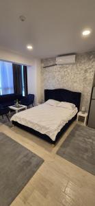 a bedroom with a bed and a stone wall at Mamaia Nord - Studio in Mamaia +6 photos