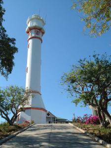 a lighthouse on the side of a road at Aiko Beach Isla Sunrise Resort in Bolinao