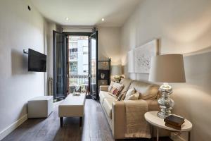 a living room with a couch and a table at BBarcelona Rogent Flats in Barcelona