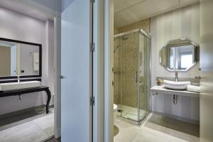 a bathroom with a sink and a glass shower at BBarcelona Rogent Flats in Barcelona +66 photos
