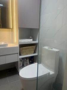 a bathroom with a toilet and a glass shower door at Condo Hotel apartment for rent in Phnom Penh City in Phnom Penh