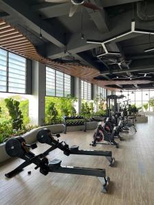 a gym with several treadmills and exercise bikes at Condo Hotel apartment for rent in Phnom Penh City in Phnom Penh