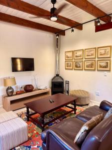 sala de estar con sofá, mesa y chimenea en Sevilo Farmhouse, en Stellenbosch