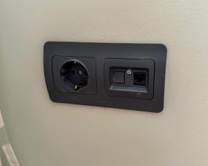 a lightswitch on a wall on a wall at NextSpace Nr 20 in Sfântu-Gheorghe
