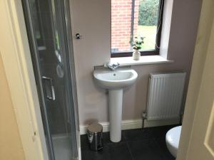 a bathroom with a sink and a shower at Applewood in South Wheatley