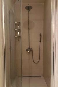 a shower with a glass door in a bathroom at Stone House Petra in Perast +32 photos