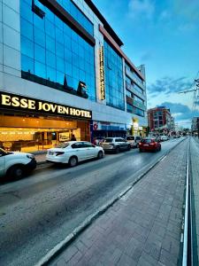 a city street with cars parked in front of a building at Esse Joven Hotel in Antalya