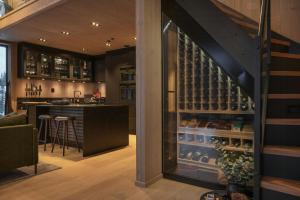 a tasting room with a bar and wine cellar at Modern Top Floor Apartment By Kvitfjell Ski Resort in Favang +10 photos