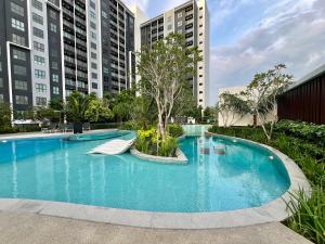 a swimming pool in a city with tall buildings at Maya Bay Residences in Banting