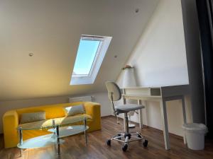 a living room with a yellow couch and a desk at Geräumiges Komfort-Schlafzimmer im Zentrum von Kassel in Kassel +51 photos
