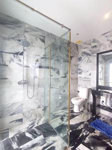 a bathroom with a shower and a toilet at BIG VILLA at CET Resort Padelcenter with Pool and Tennis in Klaeng