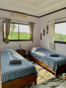 two beds in a room with two windows at BIG VILLA at CET Resort Padelcenter with Pool and Tennis in Klaeng +53 photos