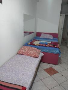a room with two beds and a mirror at Hostel Laki in Skopje