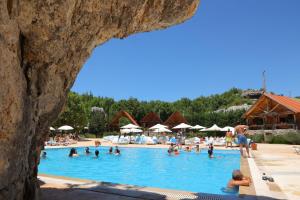 a group of people in a swimming pool at Wood Hills Hotel & Resort in Mayrūbā