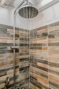 a bathroom with a shower with a glass wall at Harmony Apartment 2 in Agios Sostis