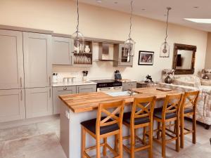 a kitchen with a large wooden table and chairs at The Forge, Newly Converted Barn in Carnforth