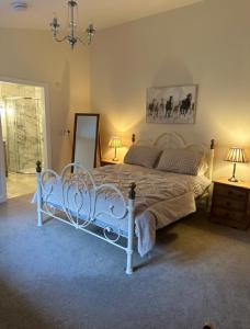 a bedroom with a white bed in a room at The Forge, Newly Converted Barn in Carnforth