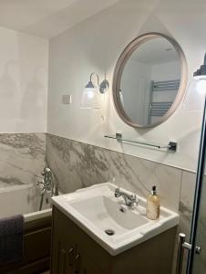 a bathroom with a sink and a mirror at The Forge, Newly Converted Barn in Carnforth +11 photos