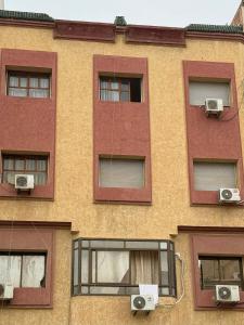 a building with three windows and two speakers at Résidence Kawtar Meknès in Meknès
