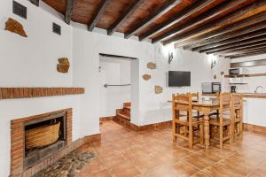 a living room with a table and a fireplace at El Pajar in Málaga