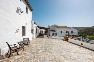 a patio with chairs and tables on a building at El Pajar in Málaga