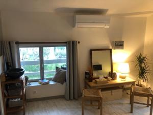 a room with a window with a desk and a mirror at Entre vignes et pierres in Vaison-la-Romaine