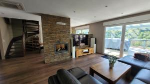 a living room with a couch and a fireplace at Moselanker de in Enkirch Mosel in Enkirch