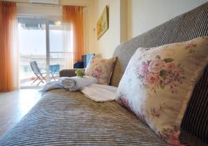 a bed with two pillows on top of it at Sunset's Nest by Golden Host in Flogita