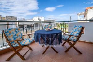 a table and two chairs on a balcony at Sunset's Nest by Golden Host in Flogita