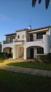 a large white building with a balcony on it at Apartamento con terraza y vistas al mar en Son Bou in Son Bou
