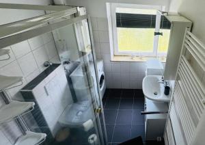 a small bathroom with a sink and a toilet at Nordsee in Wilhelmshaven +9 photos