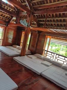 a room with four mattresses in a building with windows at Khu du lịch Đại Lâm in Thạch Thành