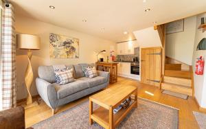 a living room with a couch and a table at The Hayloft in Ambleside