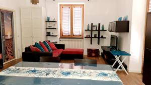a living room with a couch and a table at Coral & Turquoise in Pozzuoli