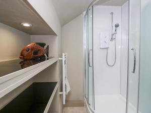 a bathroom with a walk in shower and a glass door at Osprey Cottage in Ambleside +52 photos