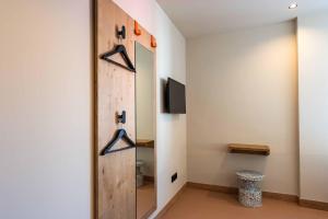 a bathroom with a sliding door and a mirror at easyHotel Madrid Alcala in Madrid