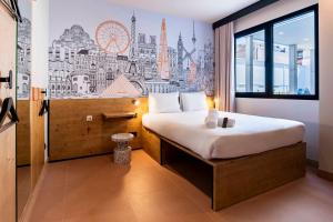 a hotel room with a bed with a city mural on the wall at easyHotel Madrid Alcala in Madrid +58 photos