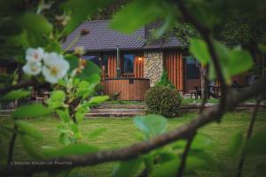 a house seen through the leaves of trees at House Arupium - HOT TUB in Otočac