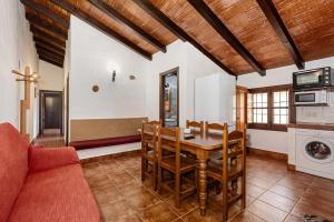 a kitchen and dining room with a table and chairs at El Granero in Málaga