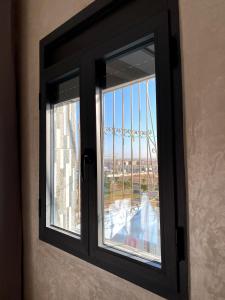a window with a view of a city through it at Razan's Cozy Corner in Agadir