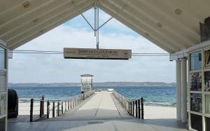 a pier with a sign that reads shingle chesapeake at Schoen - Ferienwohnung Glücksand in Sandwig