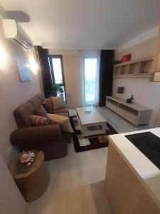 a living room with a couch and a table at Nice 2 Room Apartment Harmony Suites 3 Sunnybeach in Sunny Beach