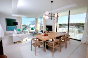 a living room with a wooden table and chairs at Monte Rei 2 bed Apt in Vila Nova de Cacela