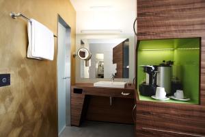 a bathroom with a sink and a mirror at Hotel Belvoir Lake View & Spa in Rüschlikon
