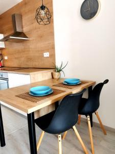 a kitchen with a wooden table with blue plates on it at MATADOR apartment & Free Parking in Bratislava