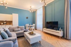 a living room with a couch and a tv at Resort Červený dvůr - apartmány a wellness in Rapotín +151 photos