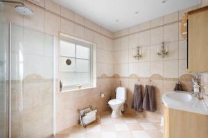 a bathroom with a toilet and a sink at Fantastisk Villa med extra allt in Tyresö +29 photos