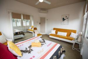 a bedroom with a bed and a living room with a couch at The Carrington Manor in Brisbane +52 photos